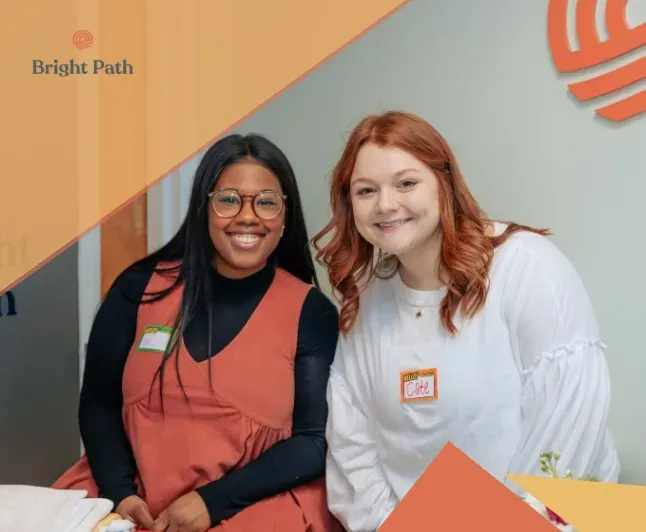 Two women smiling at a Bright Path community open house