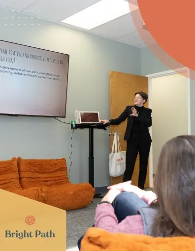 Speaker giving a presentation to a group in a Bright Path group room