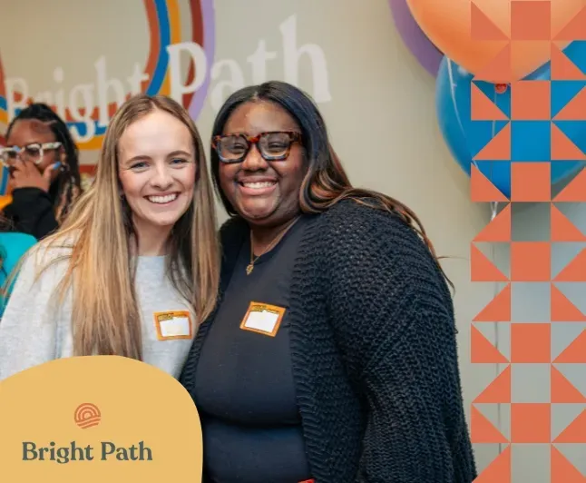 Two women smiling together at a Bright Path open house