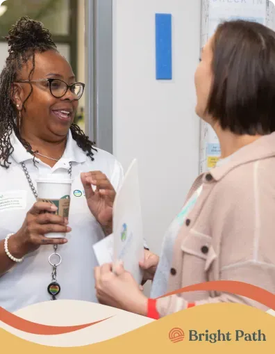 Two women talking at a Bright Path community event