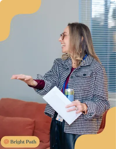 Smiling woman in a houndstooth jacket speaking at a Bright Path event