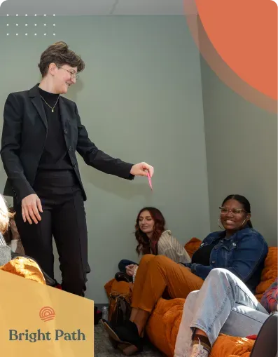Teens seated on orange floor cushions during a group activity at Bright Path