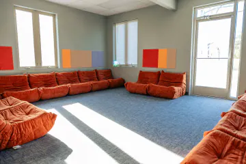 Group therapy room with orange modular seating at Bright Path