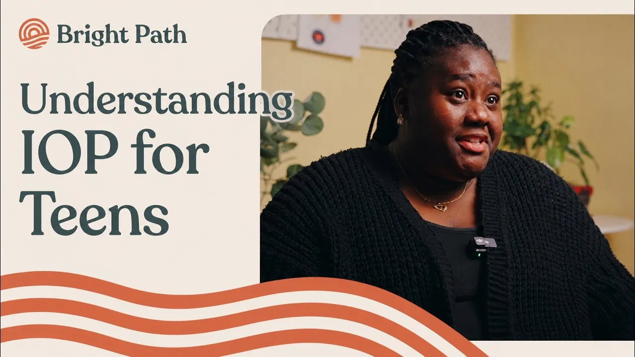 Video: Understanding IOP for Teens. Thumbnail of a woman with braids in a black cardigan beside the Bright Path logo and the video title
