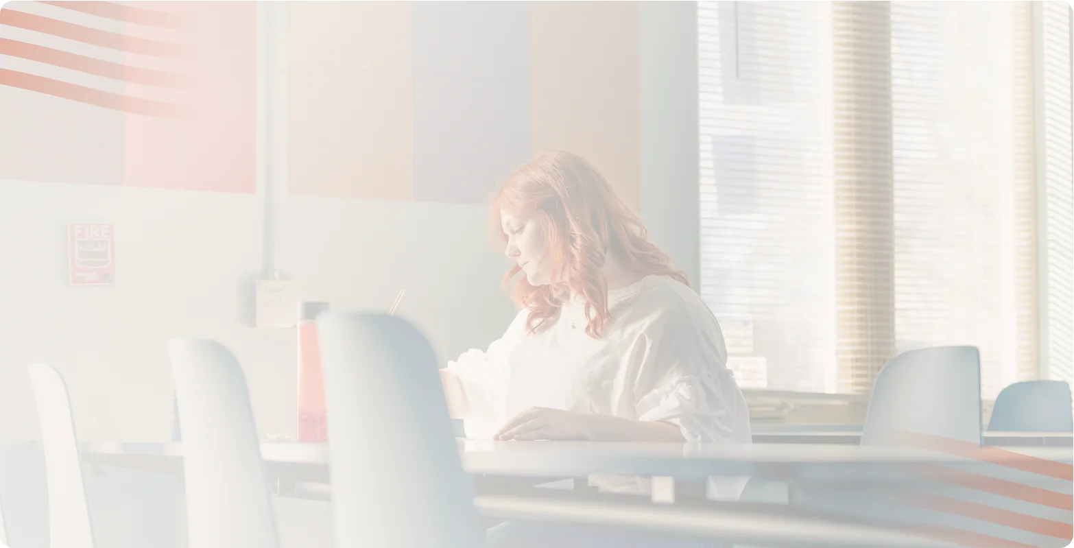 Teen with red hair writing at a table in a bright room, Bright Path teen mental health blog