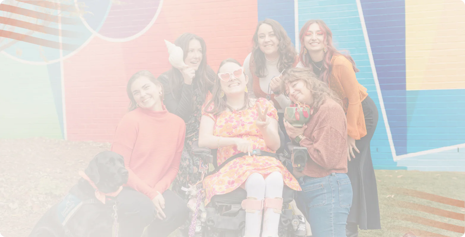 Smiling group of young people and a black service dog in front of a colorful mural, Bright Path Behavioral Health teen programs